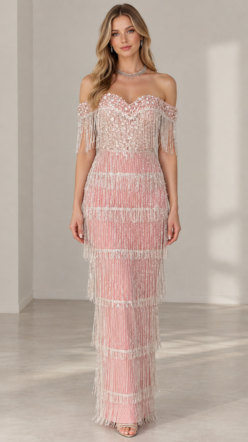 Front view of model wearing off-the-shoulder blush pink beaded fringe maxi evening gown