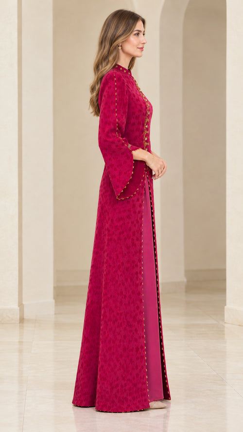 Side profile view of the magenta textured jacquard maxi gown showcasing sleeve and skirt drape