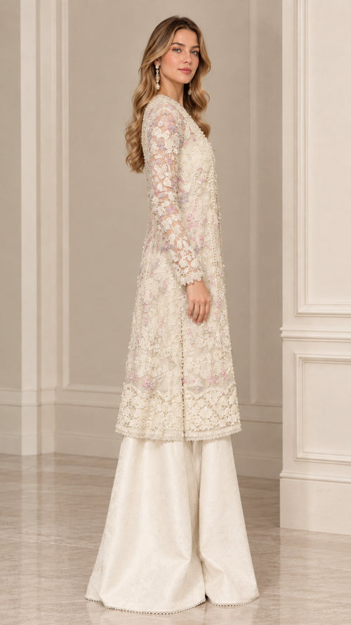 Side view of woman posing in cream floral lace long tunic and matching palazzo pants