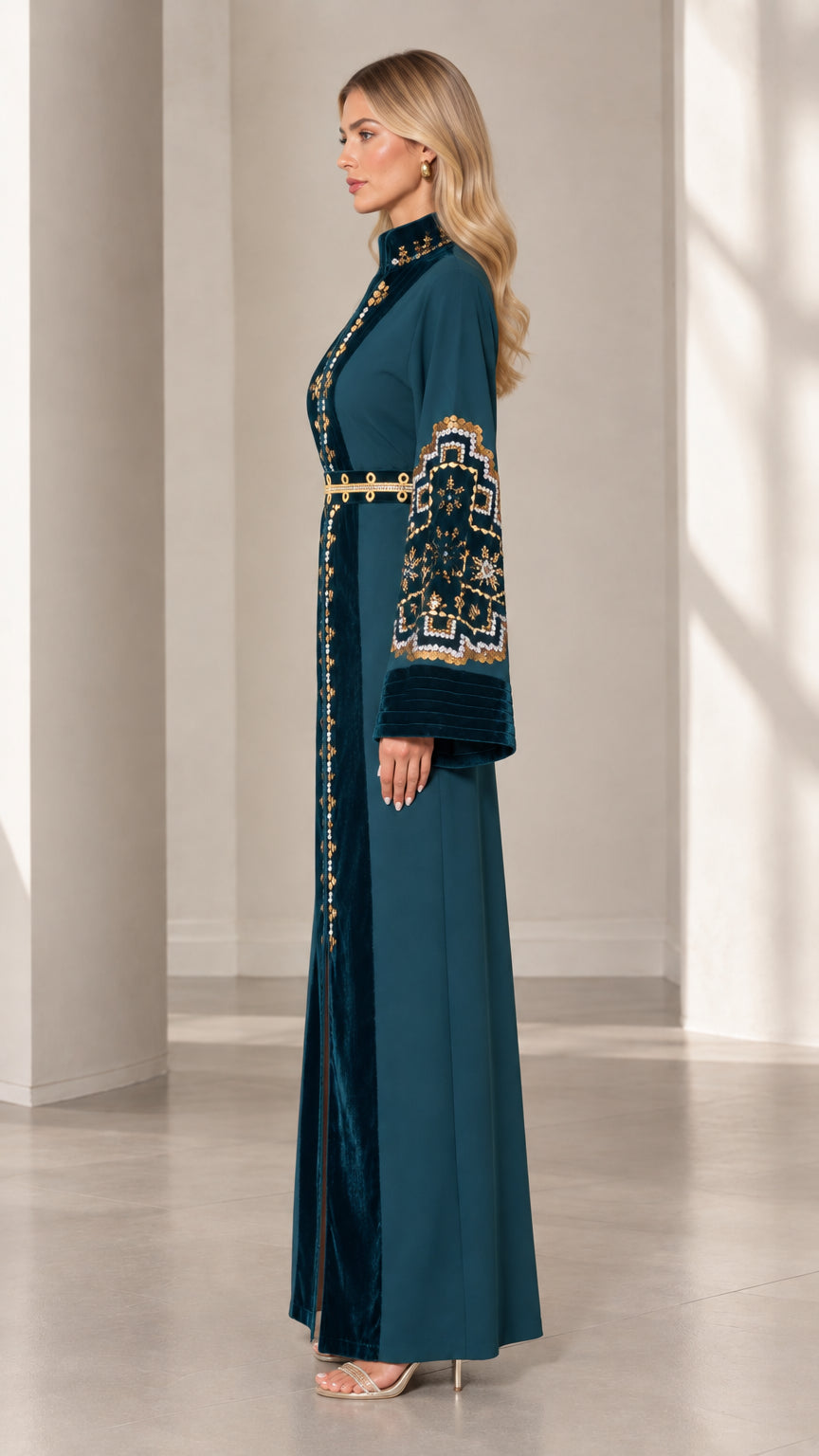 Side profile view of woman wearing teal long sleeve embroidered kaftan dress