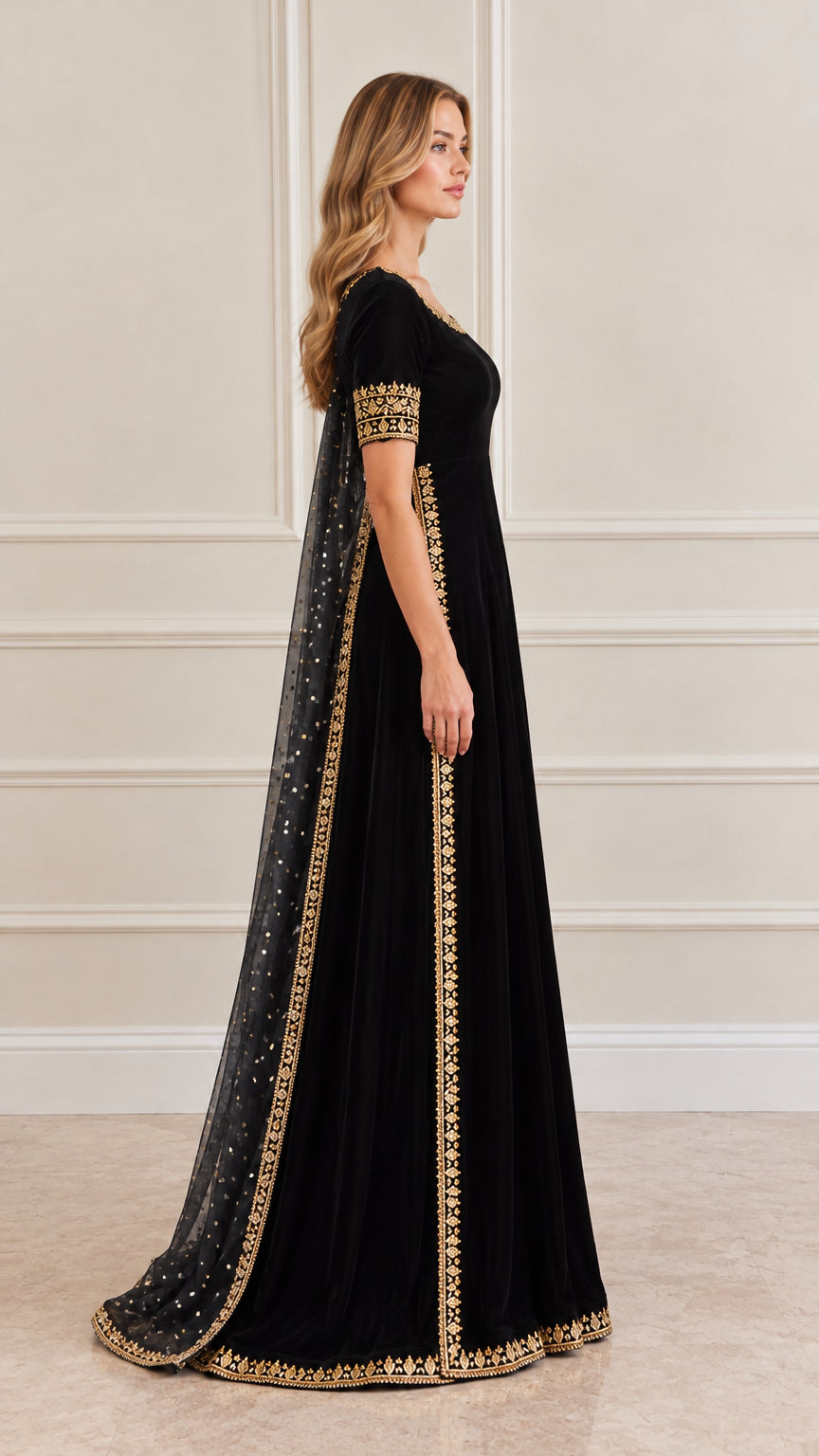 Side profile of women's black velvet embroidered evening gown