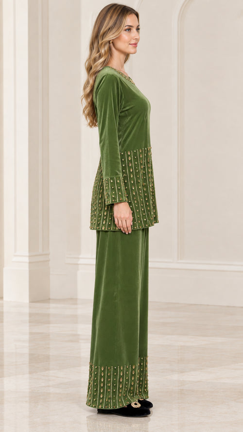Side profile view of woman wearing olive green velvet 2-piece set