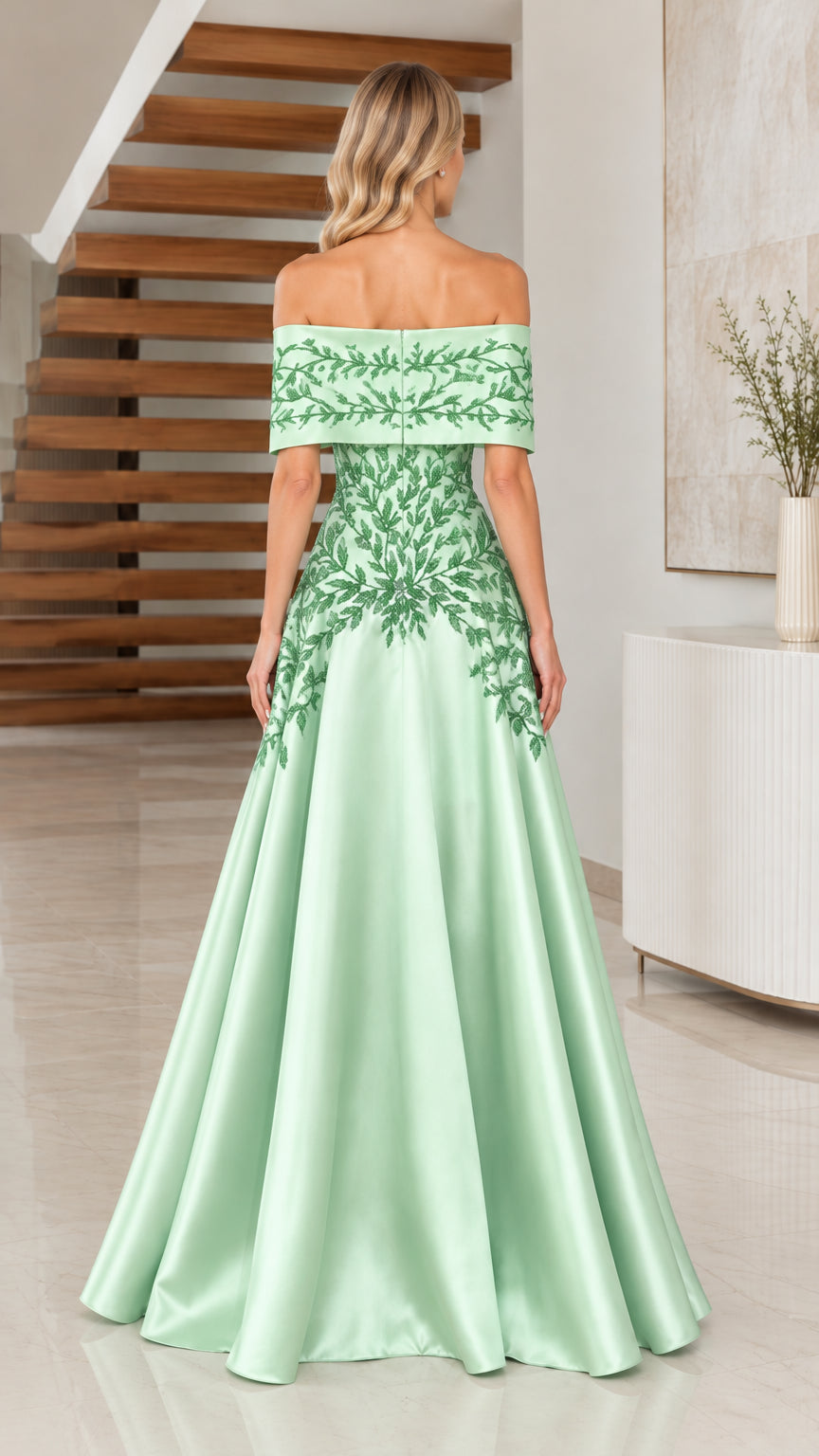 Back view of model in Sage Green off-the-shoulder satin ball gown