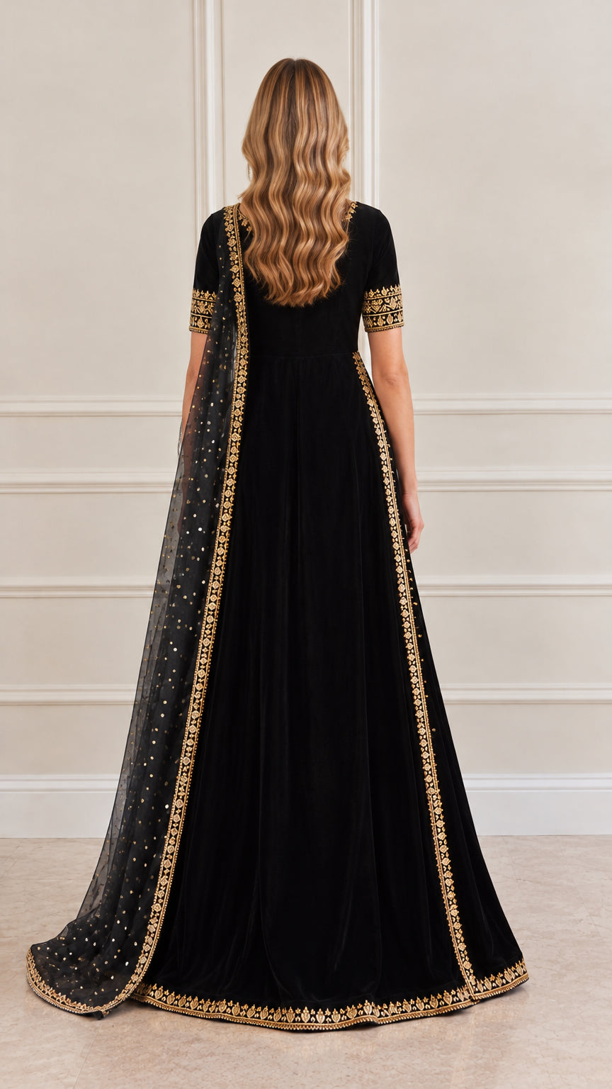 Back view of black velvet gown showing back tie with tassels and sheer dupatta