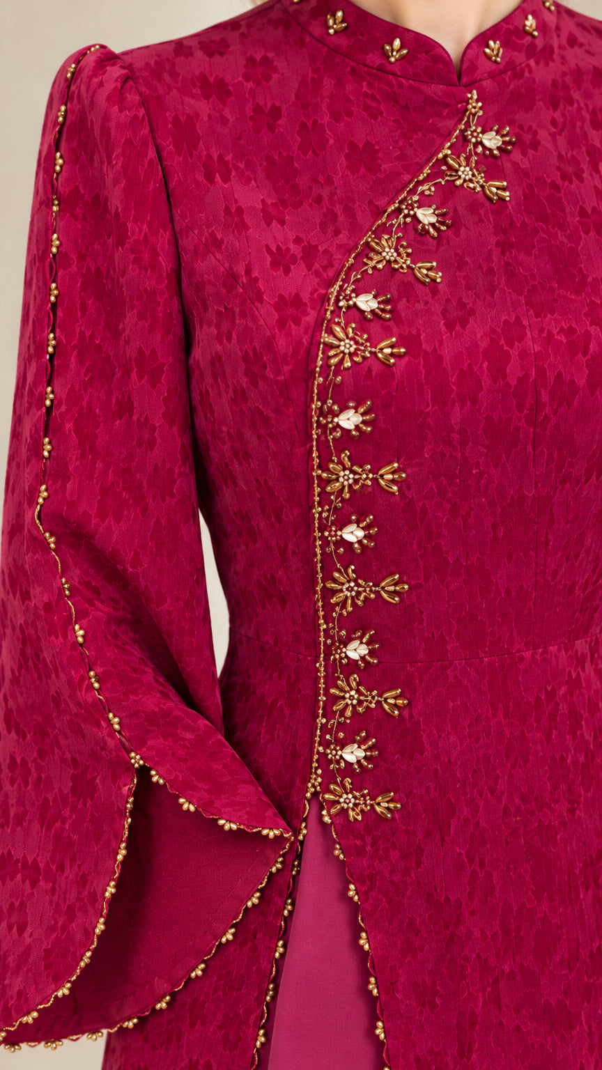 Close-up detail of golden floral beadwork and embroidery along the neckline, bodice, and bell sleeve cuff