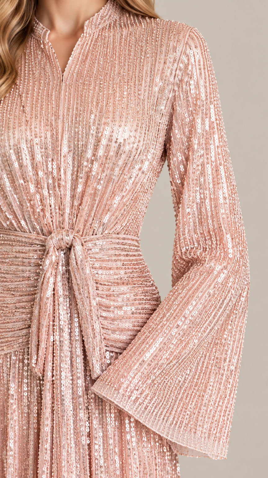 Close-up detail of sequined texture, tie waist, and flared sleeves