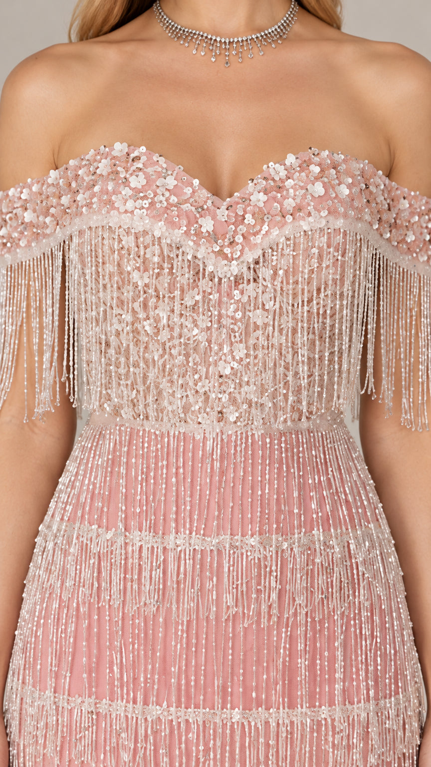 Close-up detail of blush pink sweetheart neckline with floral sequins and beaded fringe